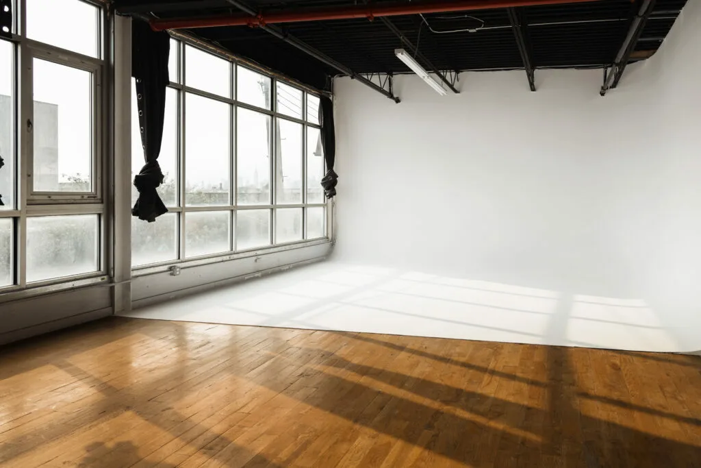 A white cyclorama wall in a large studio